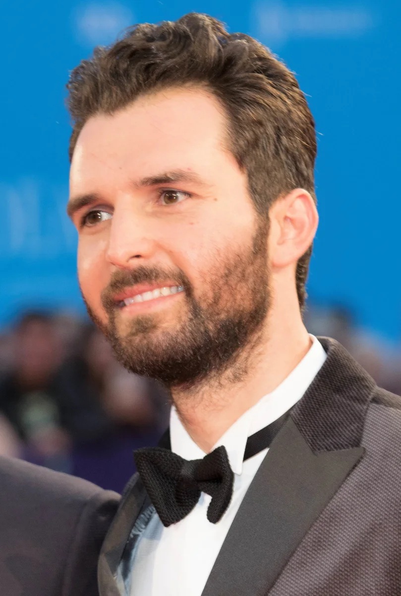 Andrea Iervolino in a tuxedo on a festival red carpet