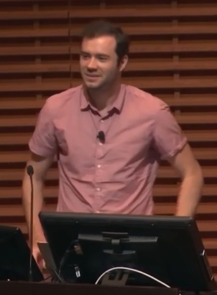 Andrej Karpathy speaking at a conference.