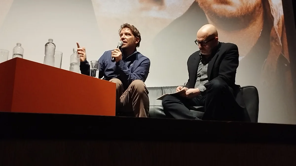Gareth Edwards speaking into a microphone during a masterclass