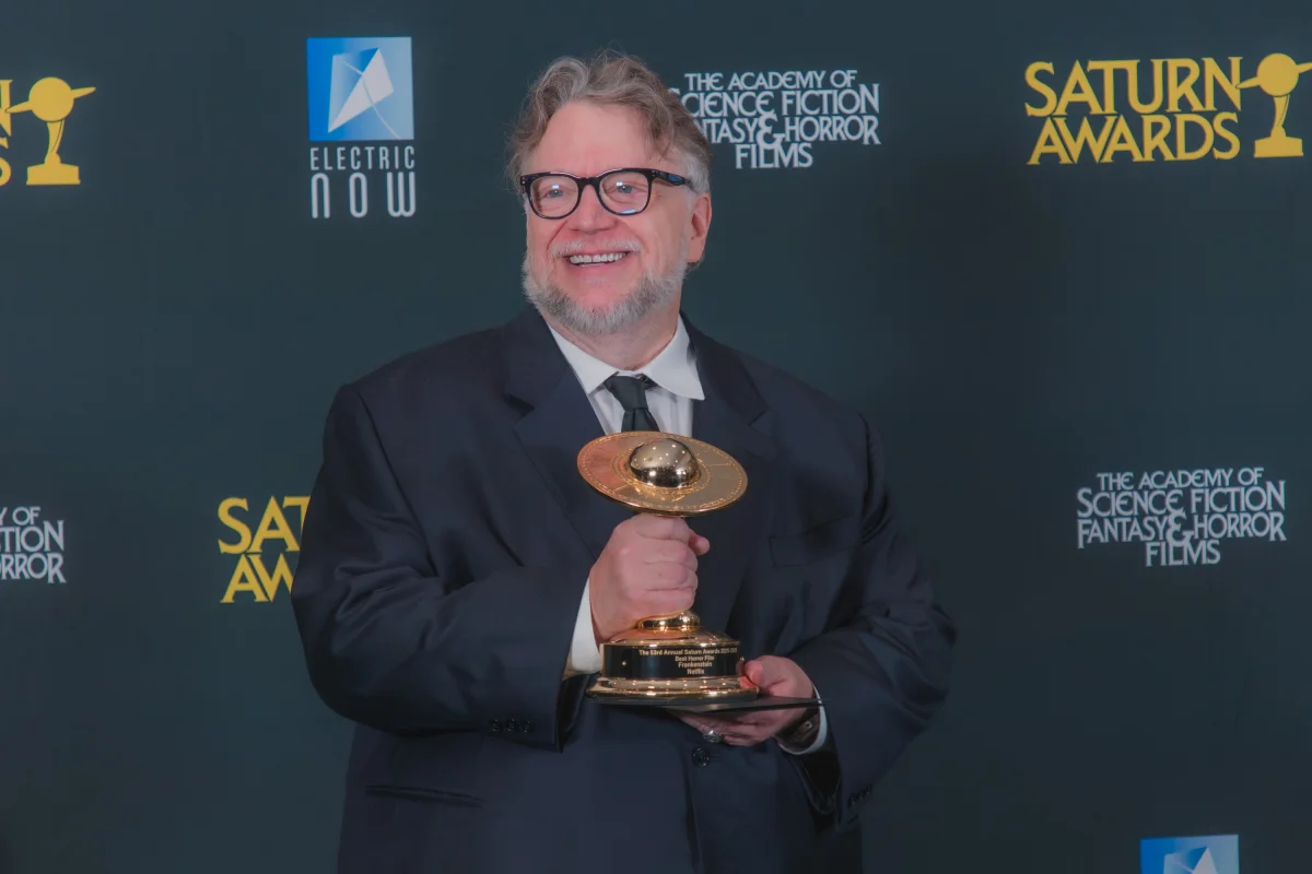 Guillermo del Toro holding the Best Horror Film trophy for Frankenstein at the 53rd Saturn Awards