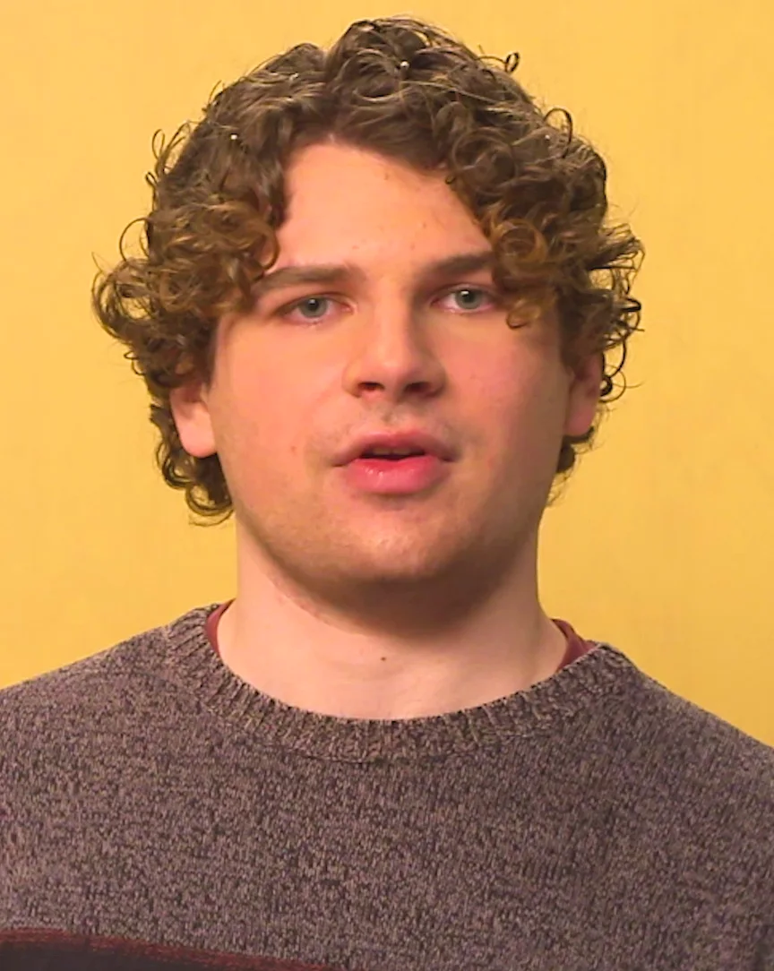 Kane Parsons during a video interview in front of a yellow background