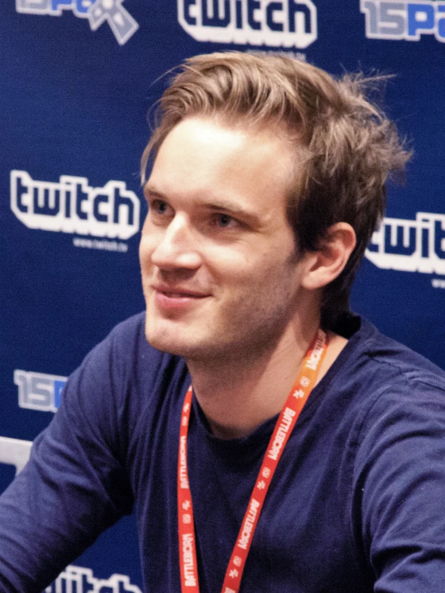 Felix Kjellberg smiling in front of a Twitch backdrop at PAX Prime