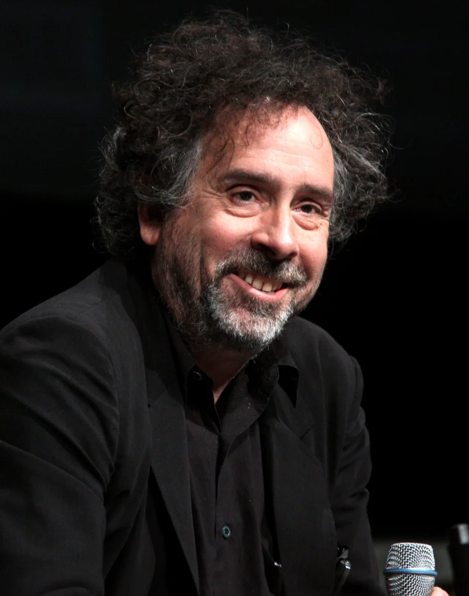 Tim Burton smiling on a panel at San Diego Comic-Con